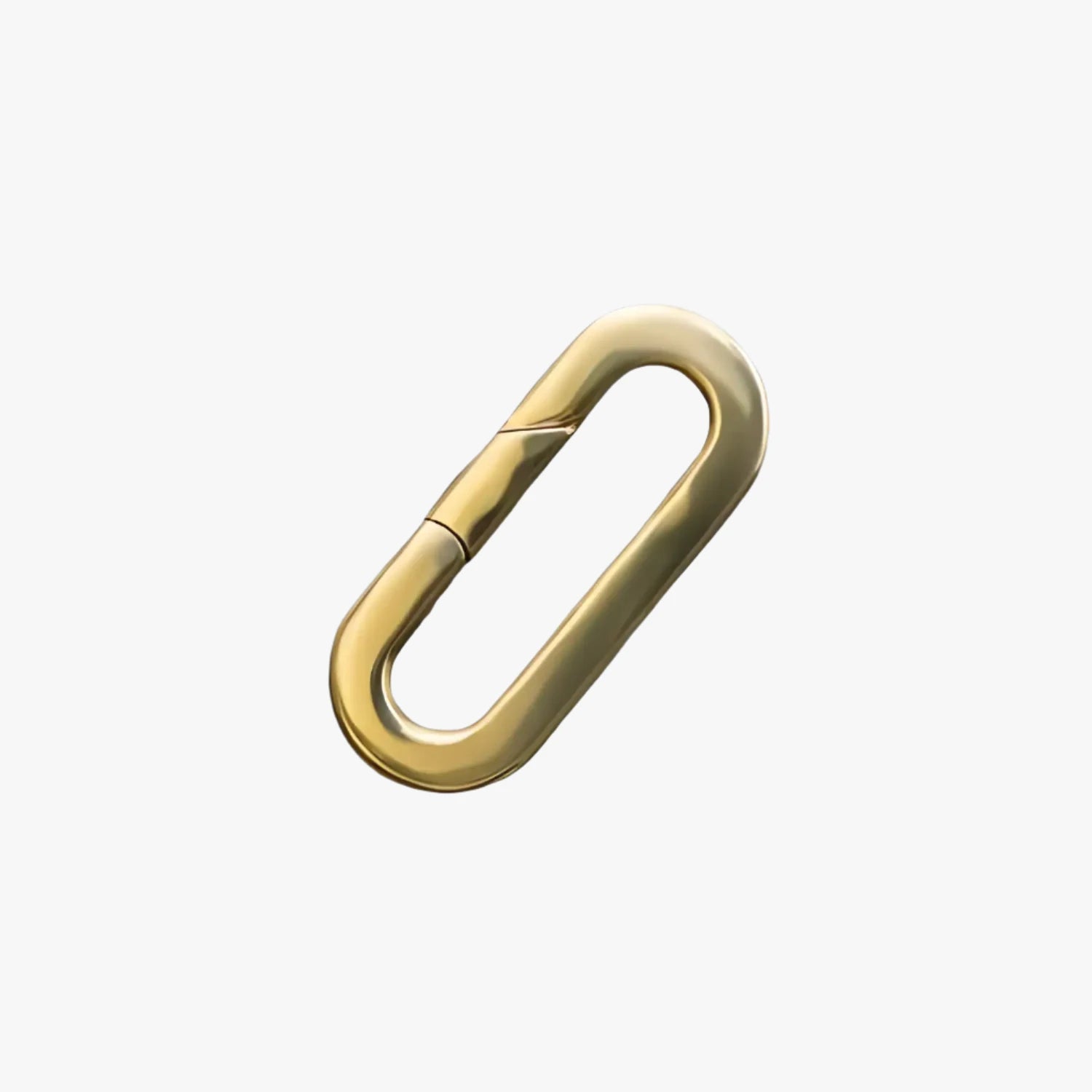 a gold paper clip on a white background