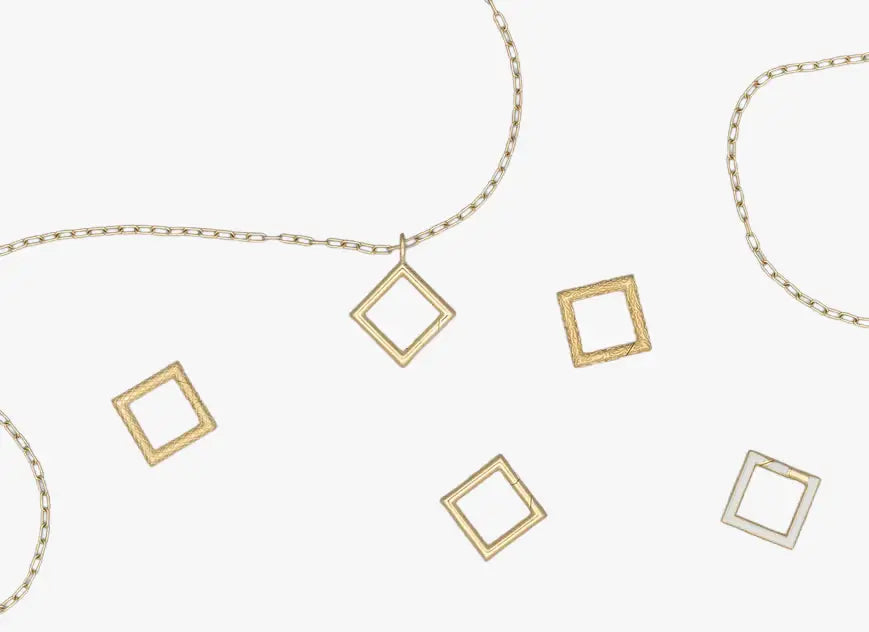 a gold necklace with square and rectangle pendants