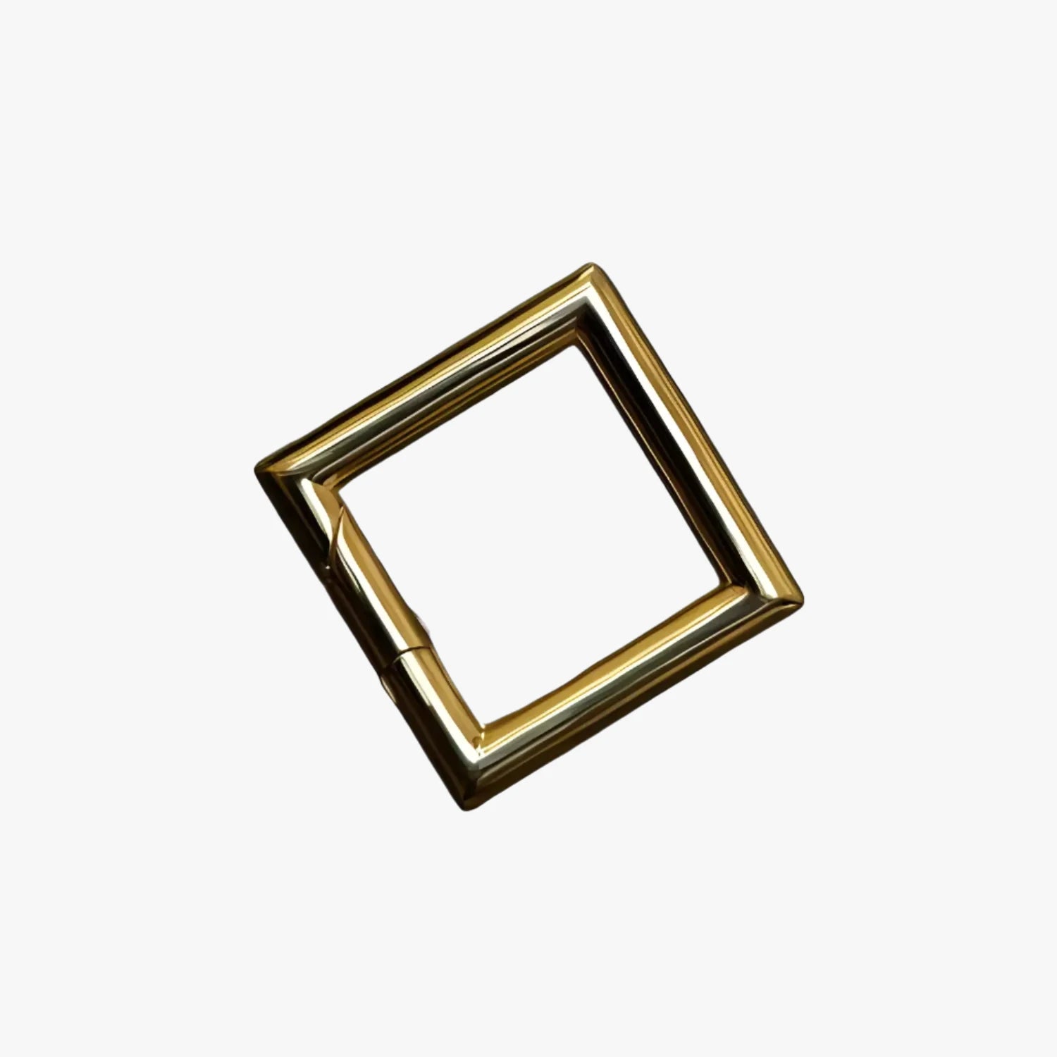 a gold square shaped object on a white background