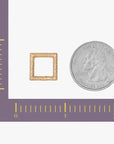 a quarter and a piece of gold are shown next to a ruler