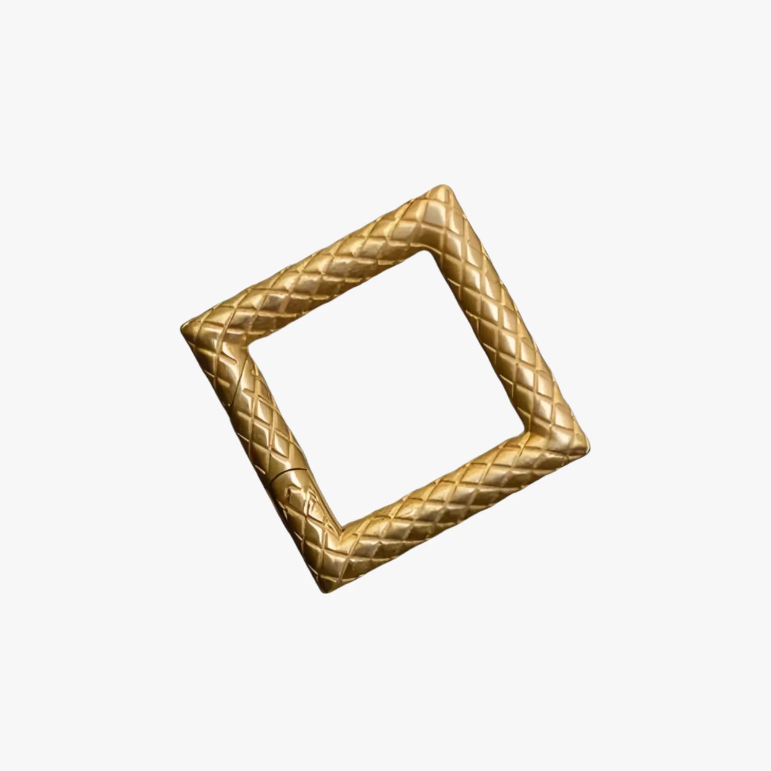 a gold square shaped object on a white background