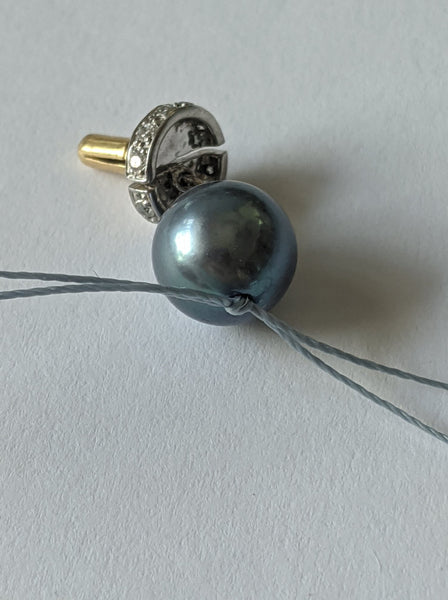 Step 11: First knot formed between the end pearl and the next one.