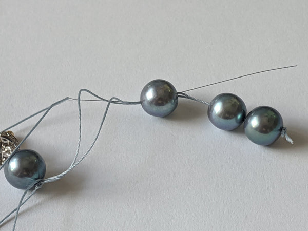 Step 12: Thread passed through the second pearl.