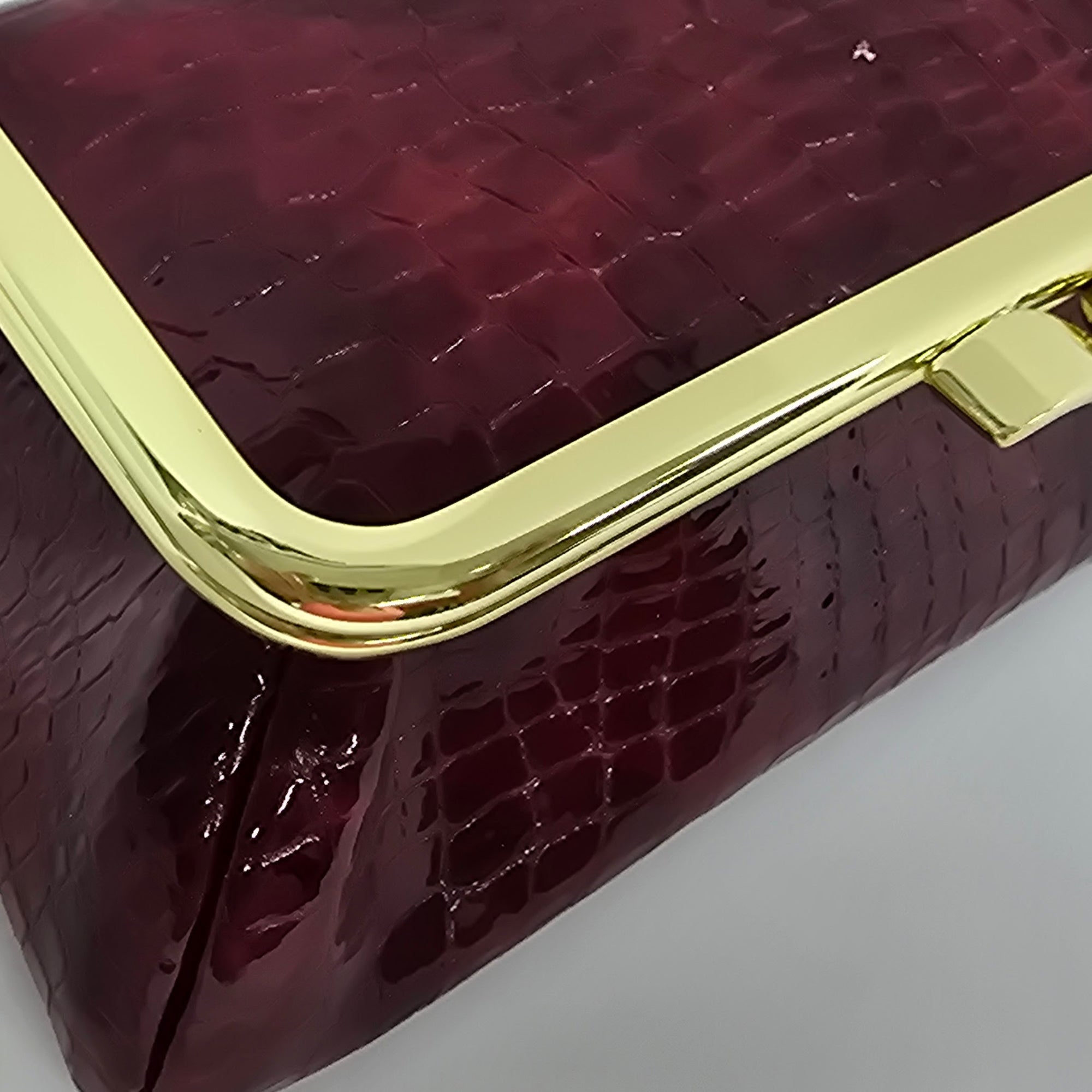 Laquered Red Snake Genuine Leather Travel Bag Gold frame detail closeup