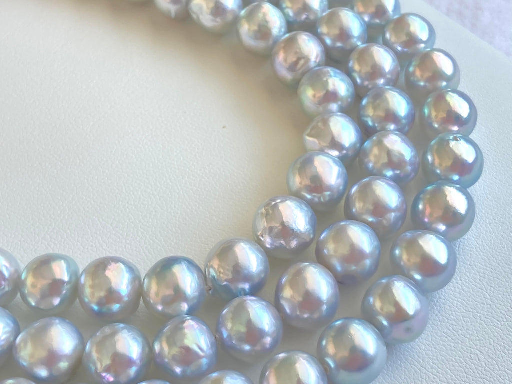 Blue Akoya pearl necklace illuminated by natural light.