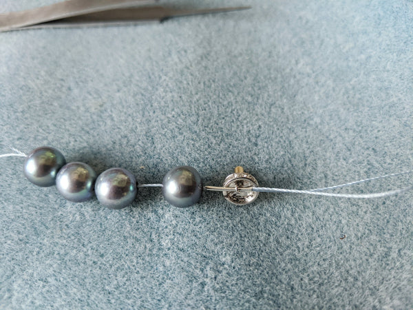 Step 10: Clasp attached and thread passed back through the first pearl.