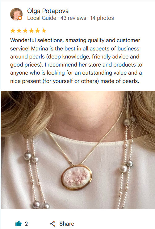 Pearl necklace with a decorative pendant worn by a person, with a five-star review above.