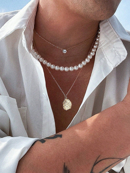 White Akoya strand worn by a man.
