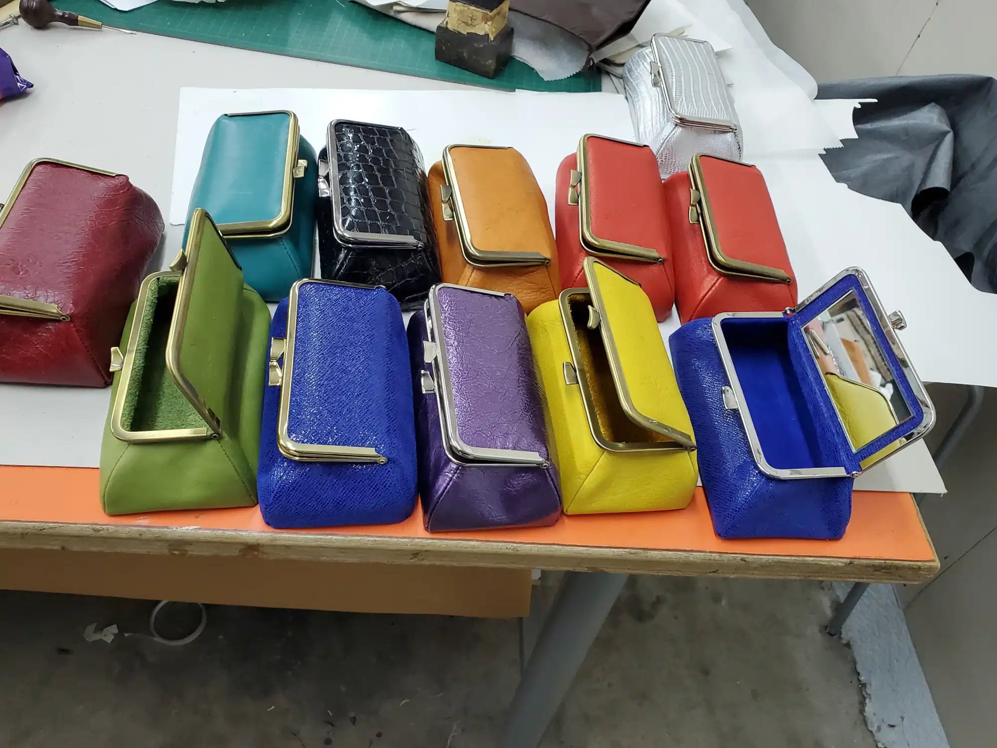 Collection of colorful leather wallets or coin purses lined up in a row.