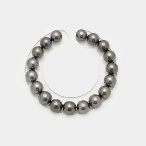 Curved strand of dark Tahitian pearls in a semicircle showcasing their elegance.