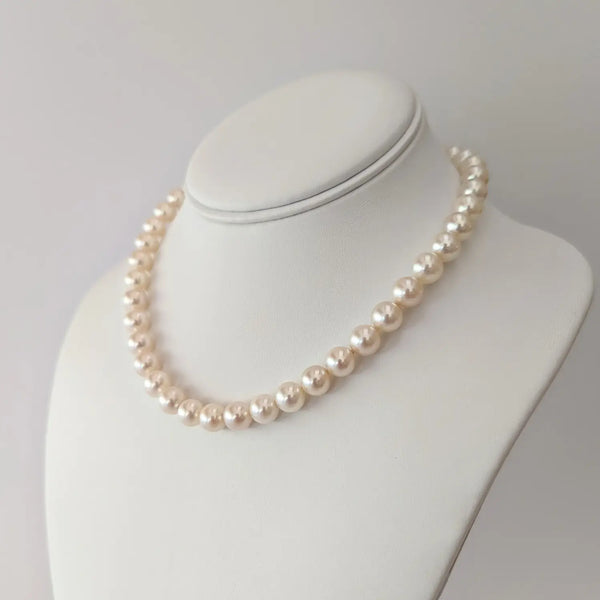 Elegant pearl necklace featuring cream-colored beads of White Akoya Pearls.