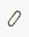 a gold metal ring with blue stones on it