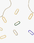 a group of different colored paper clips on a chain