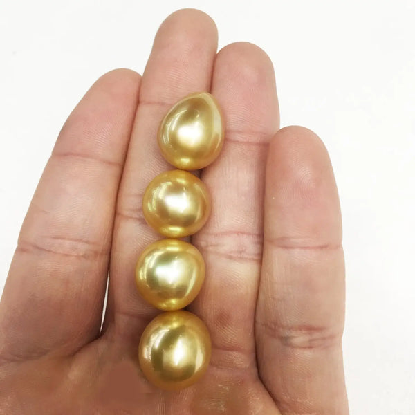 Four golden South Sea pearls showcasing surface quality by Marina Korneev pearls.