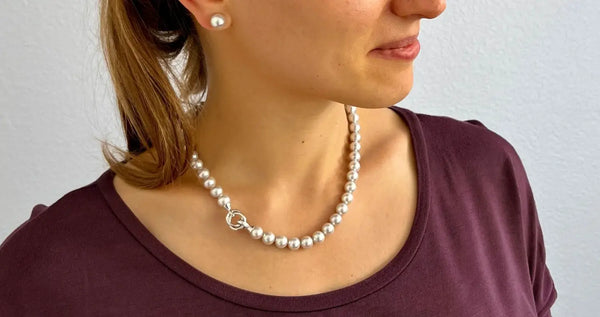 Elegant pearl necklace with a silver heart clasp from a trusted pearl merchant.