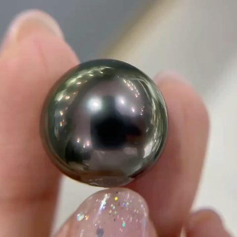 Shiny black Tahitian pearl highlighting responsible pearl farming and ocean health.