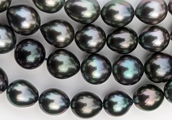 Strand of marina Korneev pearls featuring iridescent black with blue-green overtones