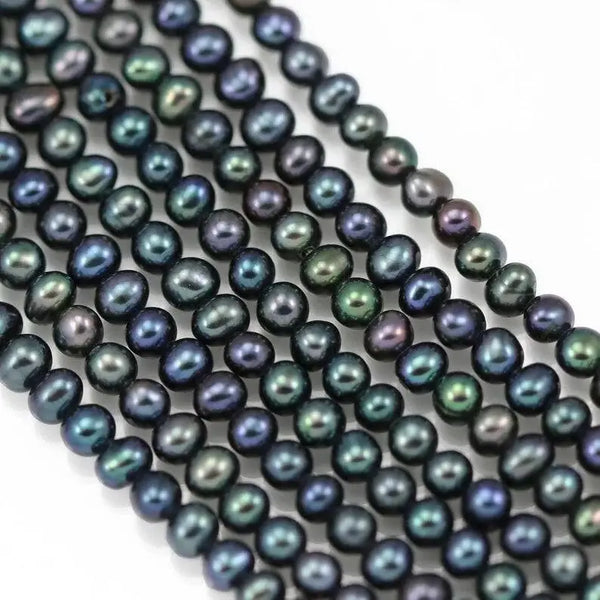 Iridescent black pearls showcasing blue-green and purple overtones in elegant display.