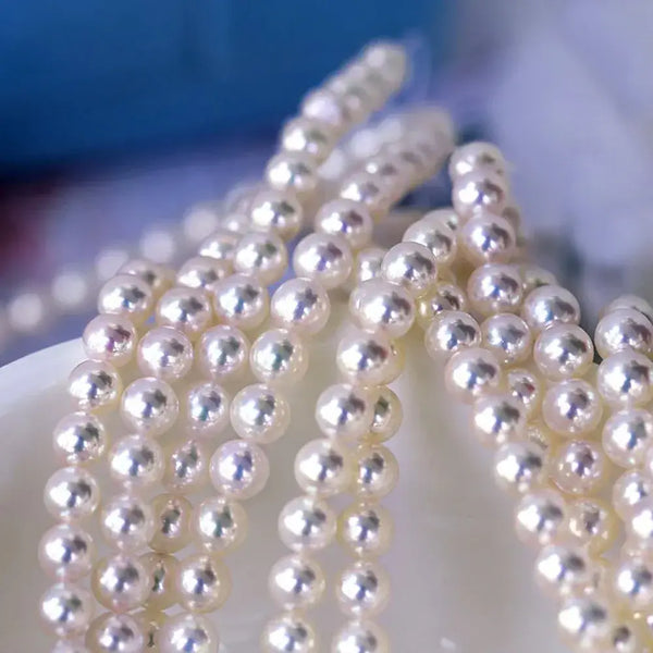 Strands of lustrous white Marina Korneev pearls showcasing exceptional surface quality.