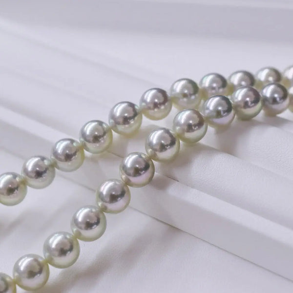 String of lustrous white pearls enhancing the allure of Blue Akoya Pearls’ mystery.