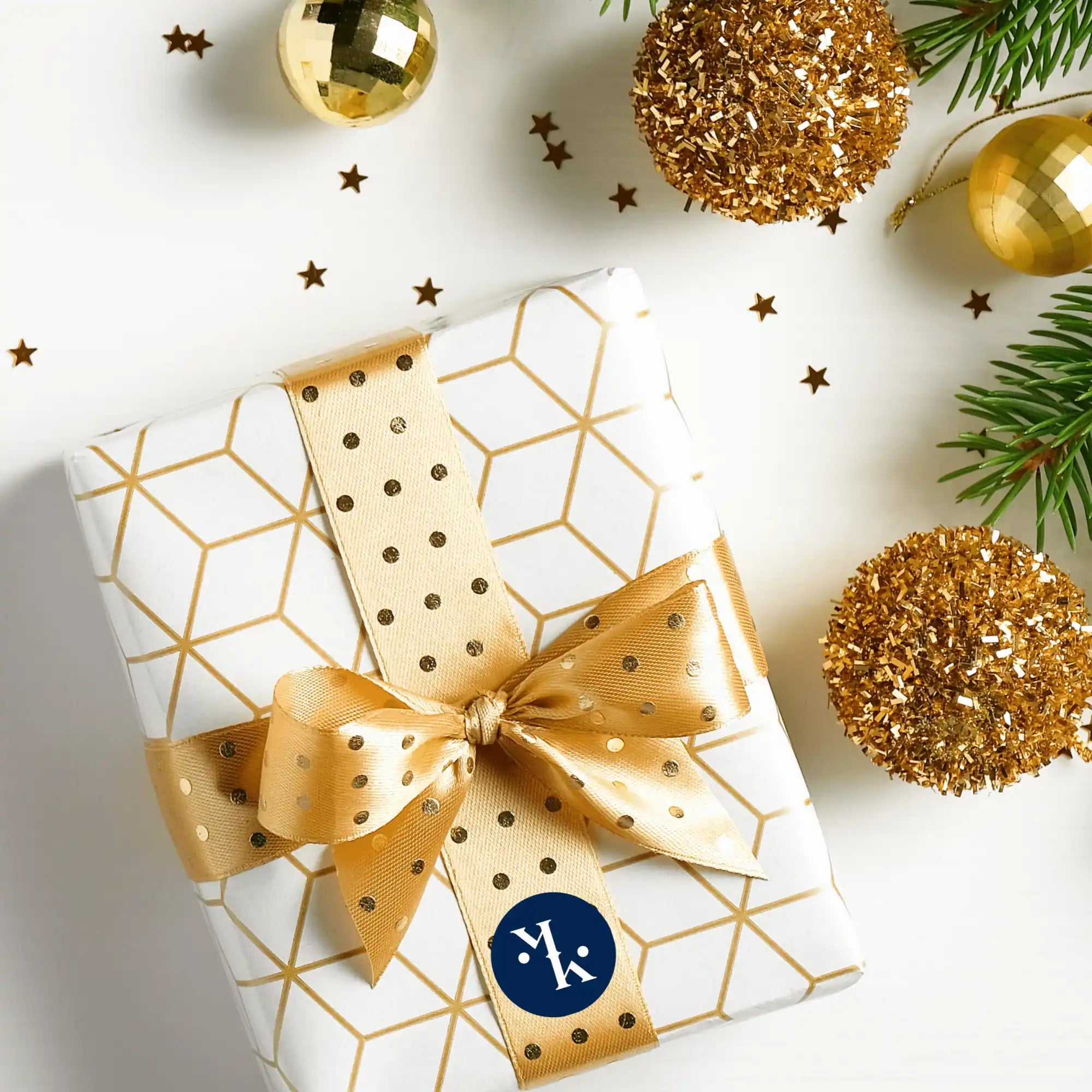 White and gold wrapped present with a shiny gold bow.